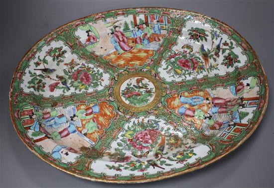 A 19th century Cantonese porcelain oval dish, decorated with panels of figures and birds, 42 x 34cm, height 4.5cm
